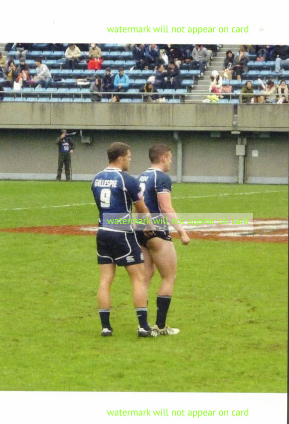 POSTCARD / Two Rugby players showing butt on field