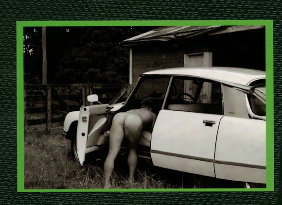 POSTCARD / Nude man leaning in car